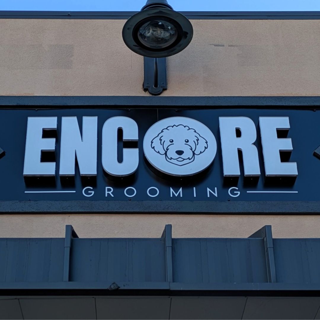 Encore Grooming sign with a cartoon dog face in the logo.
